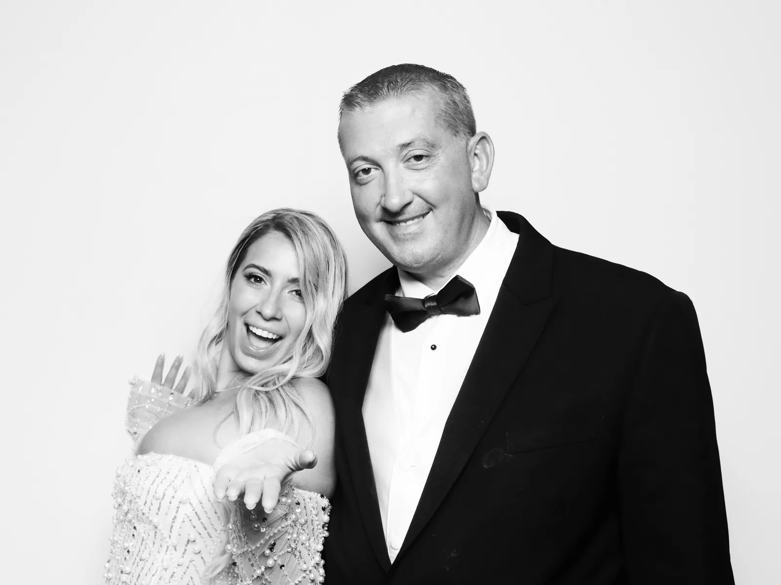 Black-tie couple in the black and white Glam photo booth in Chicago