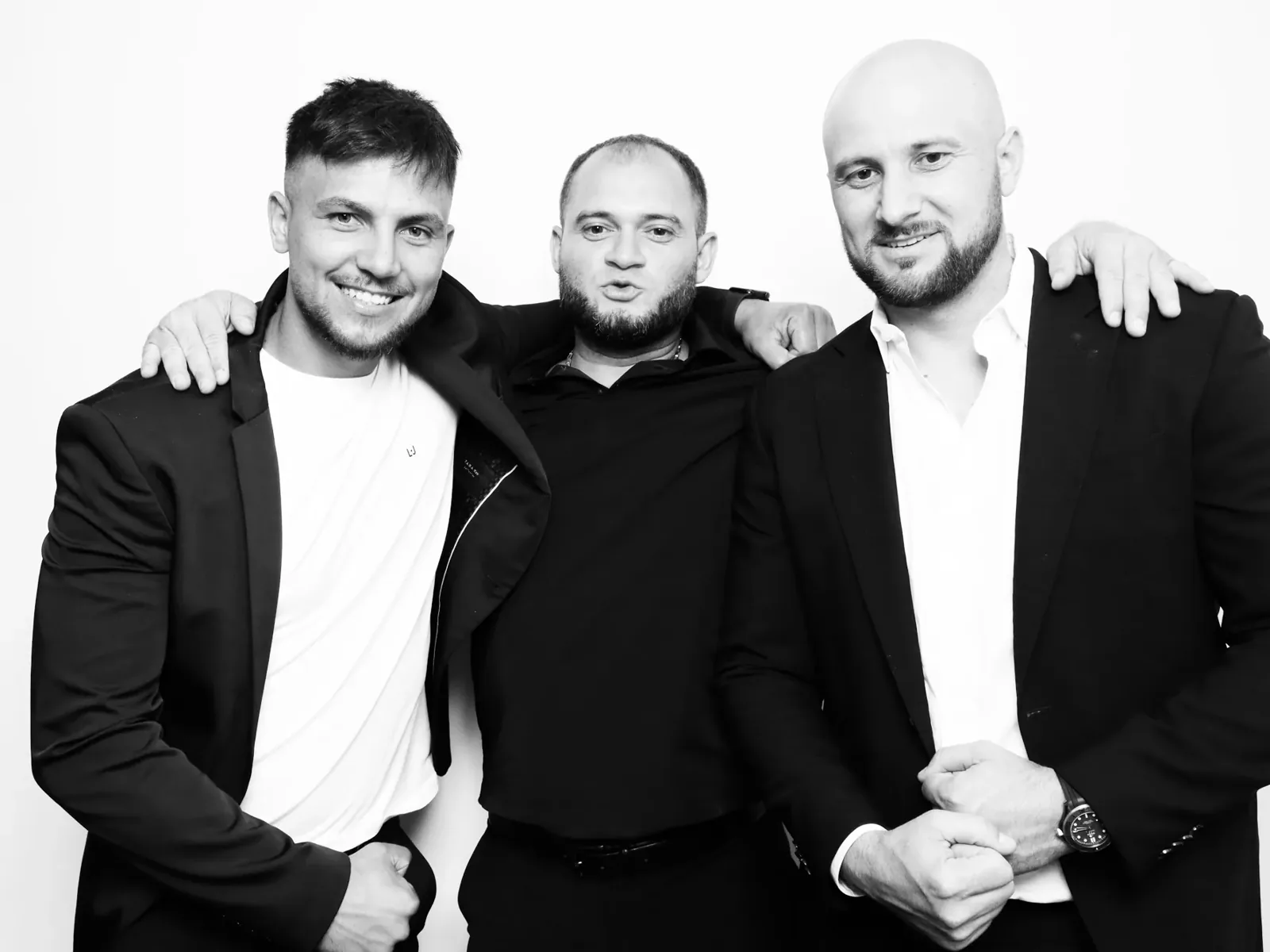 Three colleagues in suits in a black and white corporate event photo booth in Chicago