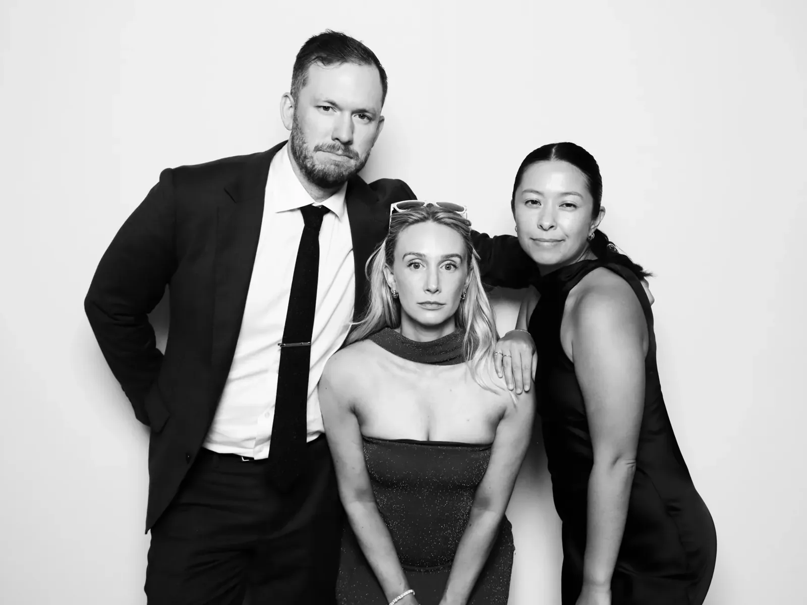 Wedding guests posing in a black and white glam photo booth in Chicago