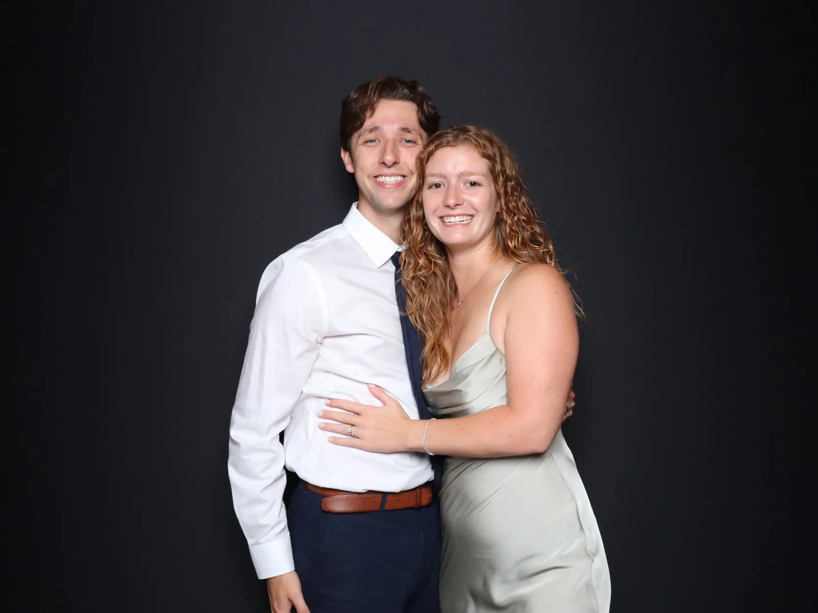 Couple portrait against a dark backdrop in the Luxe enclosed photo booth