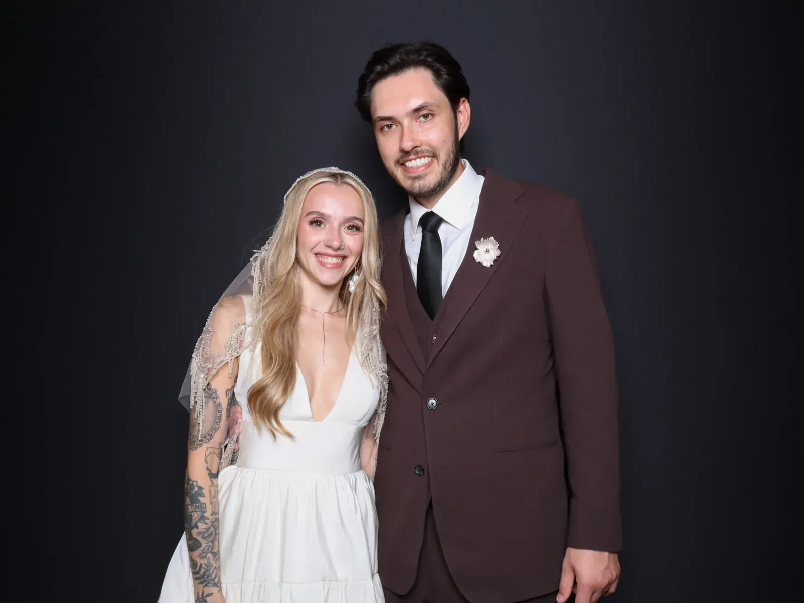 Bride and groom smiling in the Luxe photo booth at a Chicago wedding