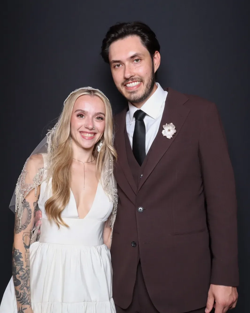 Bride and groom smiling in the Luxe photo booth at a Chicago wedding