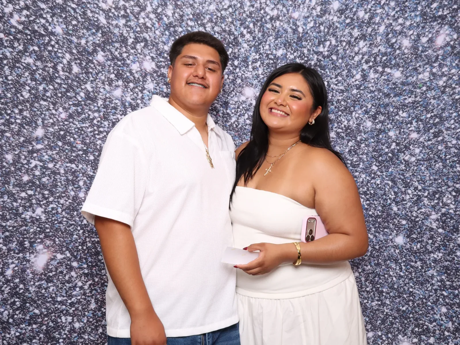 Couple in front of a sparkling sequin photo booth backdrop
