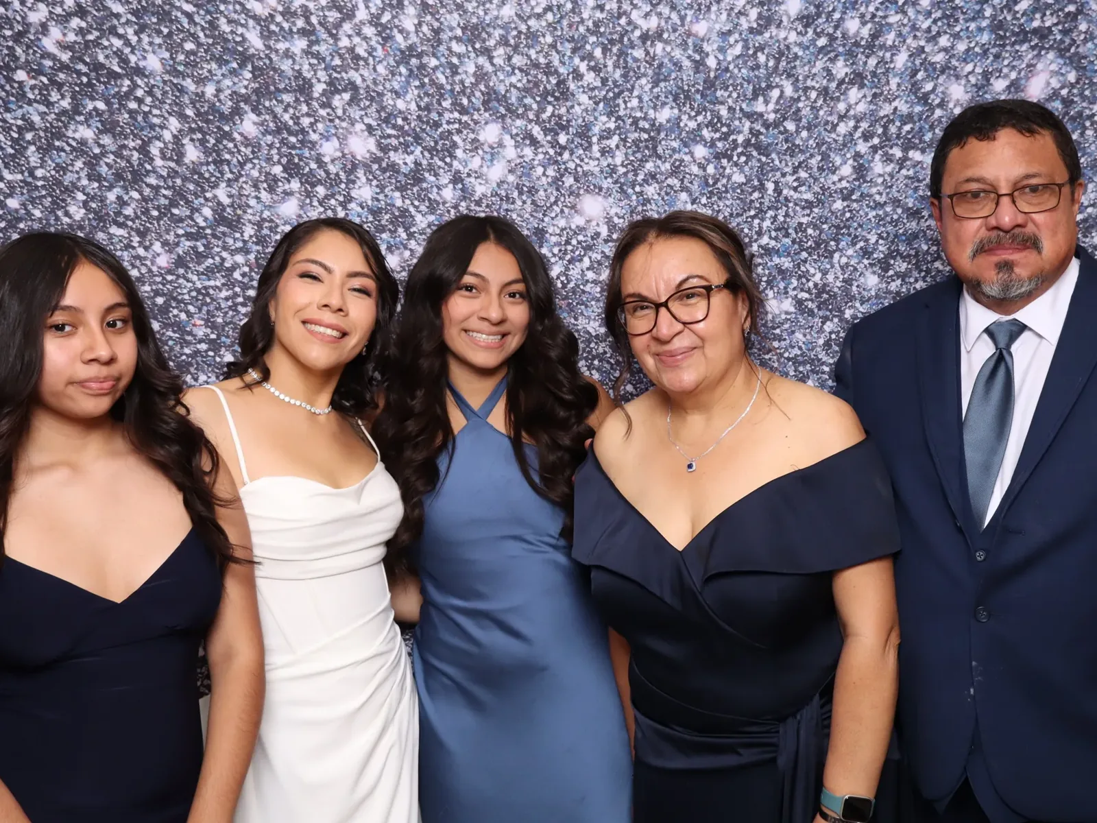 Family portrait with a silver sequin backdrop at a Chicago celebration