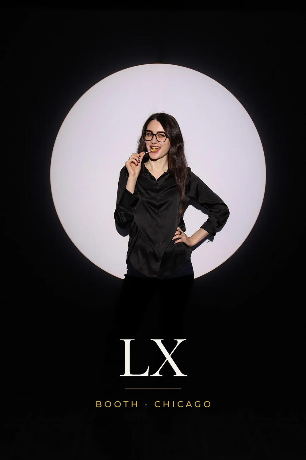 Woman in black posing in the Spotlight photo booth circle of light, 4x6 print