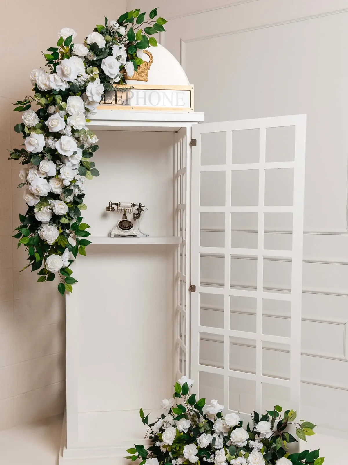 White vintage telephone booth audio guestbook with white rose florals