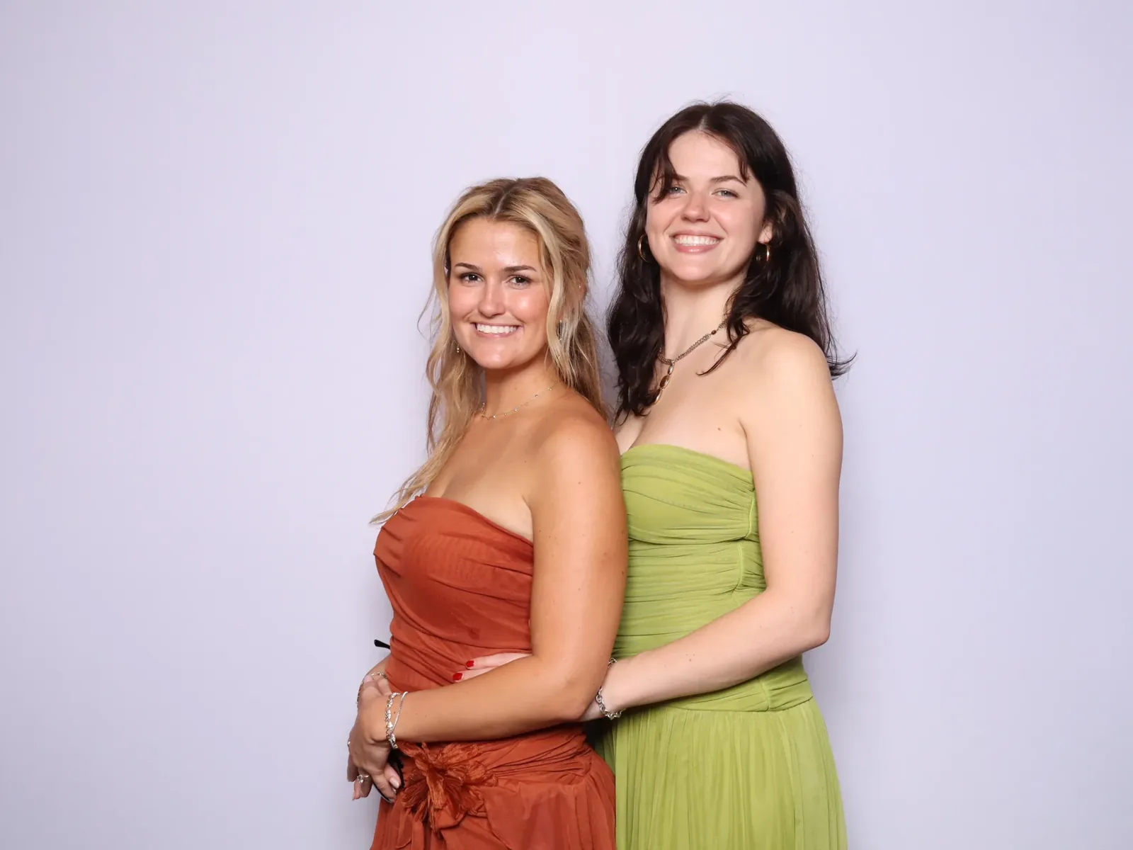 Wedding guests in colorful gowns in a photo booth